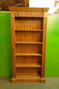 A pine open bookcase with fixed shelves and reeded frieze and front, 40" x 11" x 68"