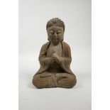 A Chinese carved, painted and distressed wood Buddha, 9" high