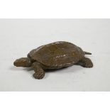 A Chinese bronzed metal tortoise, character inscription to shell, 3" long