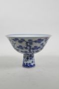 A Chinese Ming style blue and white porcelain stem cup decorated with native flora, 6 character mark