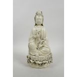 A Chinese blanc de chine Quan Yin seated on a lotus throne holding a ruyi and pearl, impressed