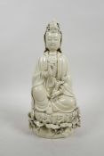 A Chinese blanc de chine Quan Yin seated on a lotus throne holding a ruyi and pearl, impressed