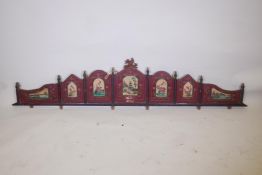 A Chinese carved and painted wood pelmet with decorative panels depicting pagodas, flowers, birds,