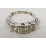 An Art Deco 18ct white gold set three stone diamond ring (total 1.3cts), size 'T' with clip to