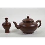 A Chinese Yixing teapot and a redware specimen vase with prunus branch decoration, both with marks
