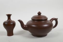 A Chinese Yixing teapot and a redware specimen vase with prunus branch decoration, both with marks