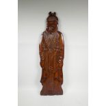A Chinese carved hardwood wall plaque in the form of an Immortal, 30½" high
