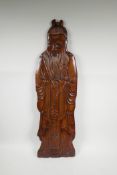 A Chinese carved hardwood wall plaque in the form of an Immortal, 30½" high