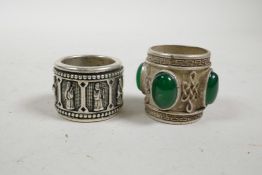 A Chinese white metal archer's thumb ring set with jade style stones, and another, 1"