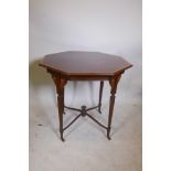 A Victorian plum pudding mahogany octagonal centre table with crossbanded inlay to the top, on