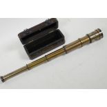 A three draw brass telescope in fitted hardwood box, bears label 'Dolland' London, 17" long extended