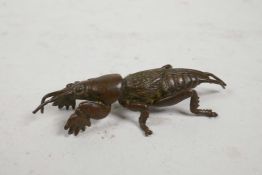 A Japanese Jizai style bronzed metal insect, impressed mark to underside, 3" long