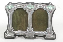 An Art Nouveau style sterling silver double photo frame with green enamel decoration, apertures