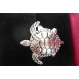 A silver ring in the form of a turtle with articulated flippers, size N/O