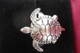 A silver ring in the form of a turtle with articulated flippers, size N/O