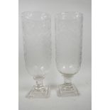 A pair of tall cut glass hurricane lamp vases on square pedestal base, 13½" high