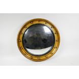 A Georgian style giltwood convex wall mirror, set in a round moulded frame with ball decoration