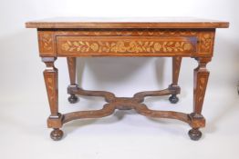 An C18th Continental marquetry inlaid walnut table with a single drawer and tapering legs united