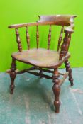 A C19th smoker's bow chair with elm seat and scroll arms
