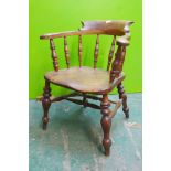 A C19th smoker's bow chair with elm seat and scroll arms