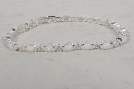 A silver, cubic zirconium and opalite tennis style bracelet