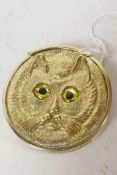 A brass vesta case embossed and engraved with a cat in the style of Louis Wain, 1¾" diameter