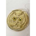 A brass vesta case embossed and engraved with a cat in the style of Louis Wain, 1¾" diameter