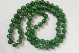 A string of green jade beads, 32" long