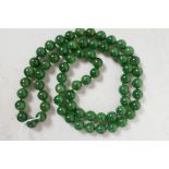 A string of green jade beads, 32" long