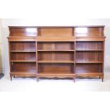 A C19th mahogany breakfront open bookcase, the upper section with dentil moulded edge, the lower