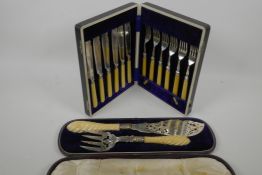 A cased pair of C19th ornate silver plated fish servers with twist ivory handles, together with a