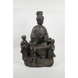 A large Chinese bronzed metal figure group depicting Quan Yin and two boys, with gilt patina, 18½"
