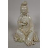 A small blanc de chine figurine of Guan Yin seated in meditation, 4½" high
