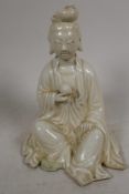 A small blanc de chine figurine of Guan Yin seated in meditation, 4½" high