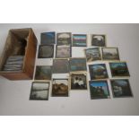 A small collection of magic lantern slides, mainly European landscapes with figures, each 3¼" square