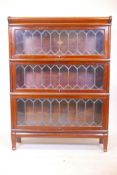 A three section mahogany Globe Wernicke bookcase with end glazed doors on plinth base, 34" wide,