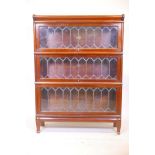 A three section mahogany Globe Wernicke bookcase with end glazed doors on plinth base, 34" wide,