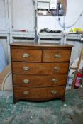 A Regency figured mahogany bowfront chest of two over three drawers, with brass oval plate