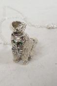 A silver whistle pendant cast in the form of a cat on a silver chain