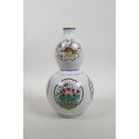 A Chinese double gourd porcelain vase with famille rose decorative panels depicting objects of