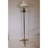 A brass Corinthian column standard oil lamp on pawed triform base, converted for electricity, 67½"