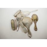 A collection of hallmarked silver dressing table items, three hand mirrors and four brushes