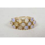 A ladies' 9ct gold ring inset with 13 Australian jelly opals, hallmarked, with original