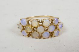A ladies' 9ct gold ring inset with 13 Australian jelly opals, hallmarked, with original