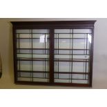 An early C19th hanging shop cabinet with two glazed doors, 60" x 6", 46½" high