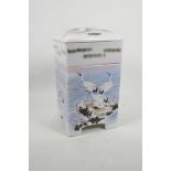 A Japanese porcelain four section stacking food container decorated with cranes above the waves,
