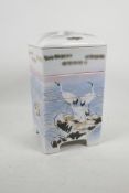 A Japanese porcelain four section stacking food container decorated with cranes above the waves,