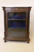 A Regency ebonised pier cabinet with fluted side columns and satinwood stringing inlay, with