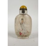 A Chinese reverse decorated glass snuff bottle depicting Quan Yin riding a carp, inscription