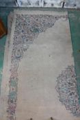 An antique Oriental carpet, with central medallion and scrolling borders, pile worn, 120" x 154"